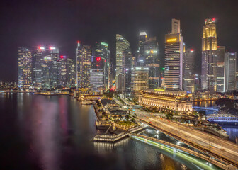 Singapore - 01 December 2024: Aerial view of vibrant central business district with modern skyscrapers and city lights reflecting on the waterfront, Raffles Place, Central Singapore Community Developm