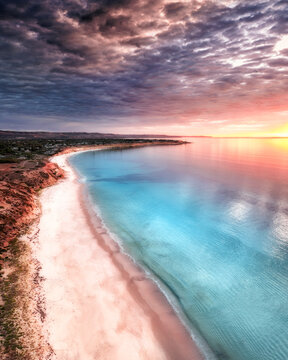 Aerial view of cliffs and ocean at sunset with beautiful clouds, Port Willunga, South Australia, Australia.