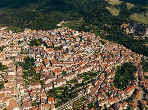 Aerial view of picturesque old town with charming terracotta roofs and winding streets surrounded by hills, Padula, Salerno, Italy.