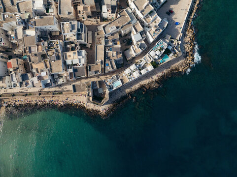 Aerial view of the historic old town and beautiful coastline with Mediterranean Sea, Monopoli, Bari, Italy.