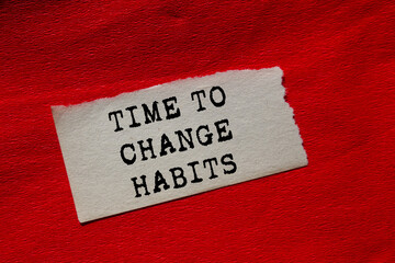 Time to change habits message written on ripped torn paper piece on red background. Conceptual time to change habits symbol. Copy space.