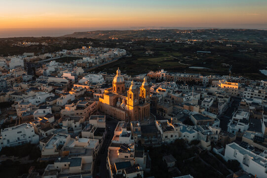 Aerial view of St. Mary's Parish Church with beautiful medieval architecture at sunset, Dingli, Malta.
