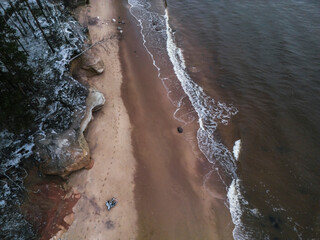 Aerial view of tranquil beach with sandy shore and gentle waves, Salacgriva Parish, Limbazi, Latvia.
