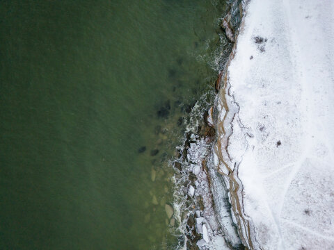 Aerial view of beautiful snowy cliffs and frozen sea at Parki cliffs, Paldiski, Harju, Estonia.
