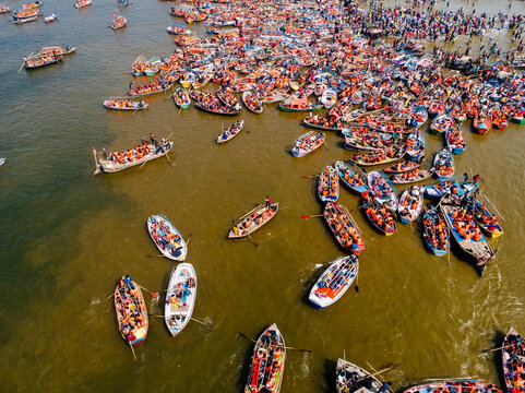 Aerial View of people gathering for Prayag Kumbh Mela along the Yamuna River, a holy festival for devotes happening in Triveni Sangam in Prayagraj, Uttar Pradesh, India.