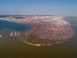 Aerial View of people gathering for Prayag Kumbh Mela along the Yamuna River, a holy festival for devotes happening in Triveni Sangam in Prayagraj, Uttar Pradesh, India.
