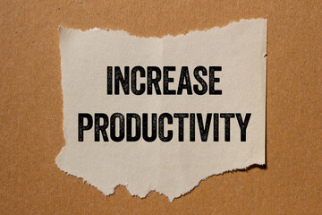 Increase productivity message written on ripped torn paper piece on brown background. Conceptual...