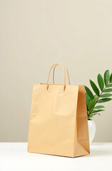 Brown paper shopping bag next to a green plant against a neutral background. Eco-friendly shopping.