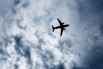 Airplane Silhouette Against Cloudy Sky
