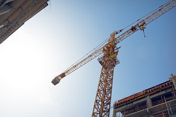 Construction crane at work site under clear sky