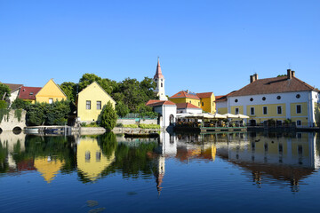 European village, town, lake with stunning water reflections. Historic architecture, old town, including a church, temple and traditional houses. Travel and tourism destination summer and spring. 