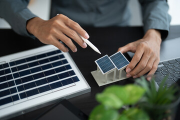 Solar panels green energy Business man working  green eco friendly office business creative idea Planing Bio economy for business eco friendly professional Engineer sustainable electricity. © Charlie's