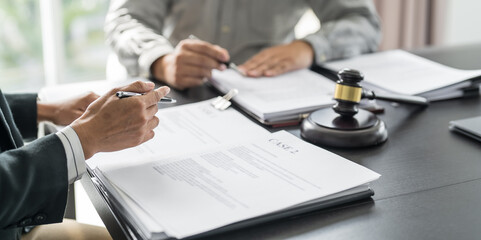 Lawyer Legal counsel presents to the client a signed contract with gavel and legal law. justice and...