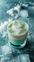 Blue cocktail with ice cubes and mint leaves