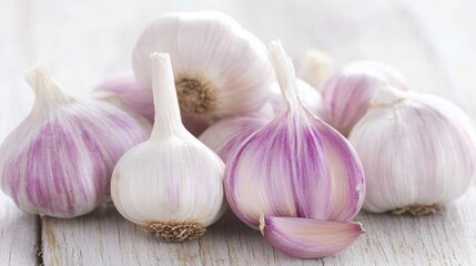 Fresh organic garlic bulbs on rustic wooden table surface