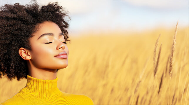 African American woman in yellow sweater with closed eyes in golden wheat field. Her peaceful expression perfectly captures mindfulness, serenity and natural wellness concepts with text space.