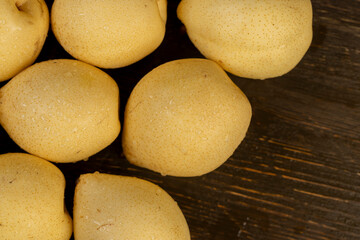 ripe white pear with a yellow colour on the table