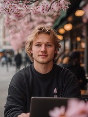 A young professional working remotely on a laptop in a picturesque city, embracing digital nomadism and modern working culture