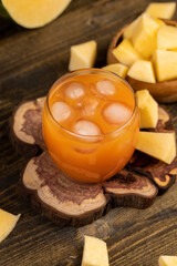 pumpkin juice in a glass and sliced ripe pumpkin