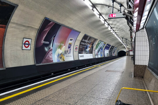 London, United Kingdom, January 18, 2025: London Underground Station Platform with Advertising Posters