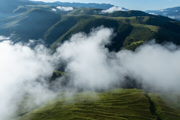 Aerial view of beautiful high altitude grassland mountain in fog landscape