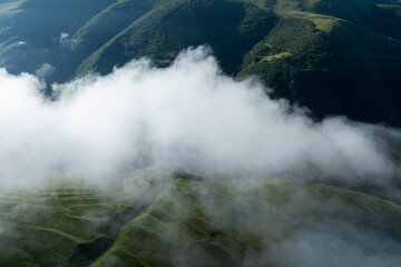 Aerial view of beautiful high altitude grassland mountain in fog landscape