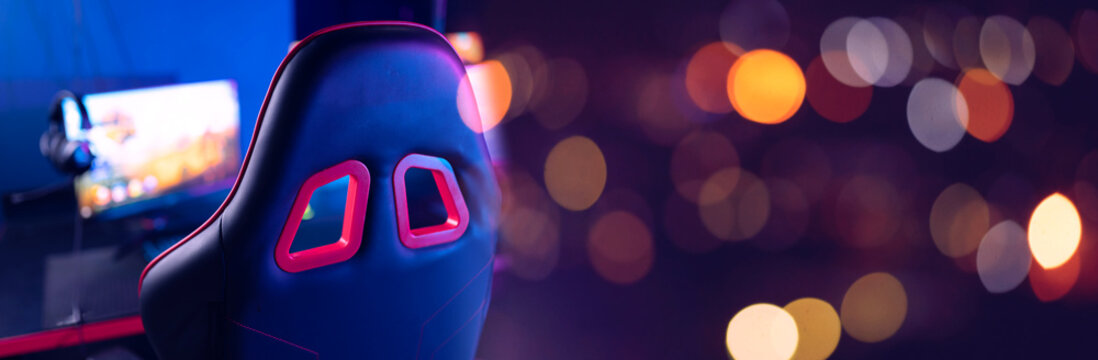 Gaming setup with chair and monitors in esports environment banner