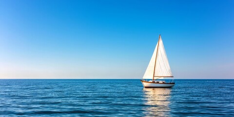 Obraz premium Tranquil Sailboat on Calm Water Under Clear Blue Sky