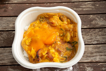 Japanese food bento box rice and fried chicken with boiled onsen egg in convenience store shop in Koto city of Tokyo, Japan