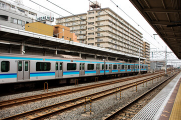 Fototapeta premium Japanese people and foreign traveler passengers wait and walking up and down journey with MRT Tozai Line trains go to Ginza at Kasai Station in Tokyo, Japan
