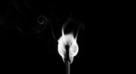 Burning Matchstick on Black - A close-up shot of a burning matchstick against a black background. Symbolizing: fragility, ignition, fleeting moment, transformation, destruction