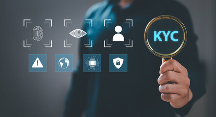 (KYC) Businessman holding magnifying glass and identity verification symbol to increase financial security and access personal financial information. Biometric security. Know your customer concept.