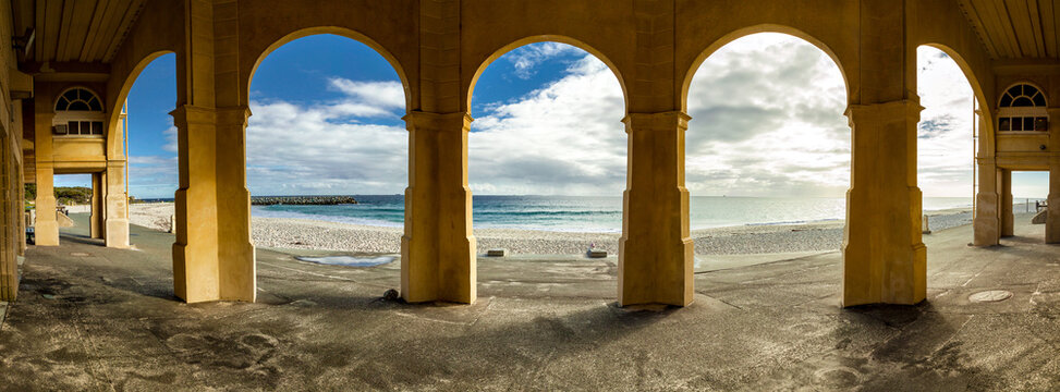 Looking out from a row of arches at the beach