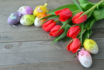 Easter background with eggs  and red tulips. Holiday card.