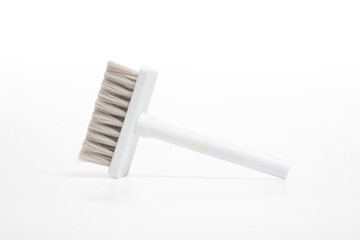 Scrub brush with gray bristles on isolated white background. Plastic dust cleaning brush.  Hygiene,...