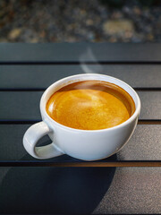 Coffee cream texture of fragrant coffee in a cup with delightful coffee foam. Top view coffee crema