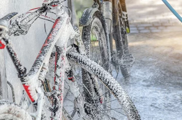Fototapete Rund Washing bicycle at car wash white foam for washing car © romankrykh