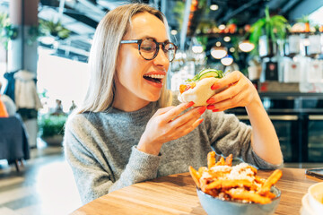 Woman Laughing While Enjoying a Steamed Bao Bun with Crispy Filling