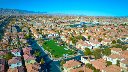 Aerial Suburban Desert Community with Central Park and Mountain Views