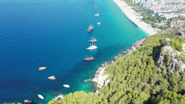 Beautiful Cleopatra beach with turquoise water and forested slopes in Alanya, Turkey