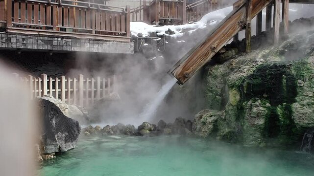 Hot spring water flowing out of a chute a main source of spring water at the Kusatsu Onsen hot spring resort.