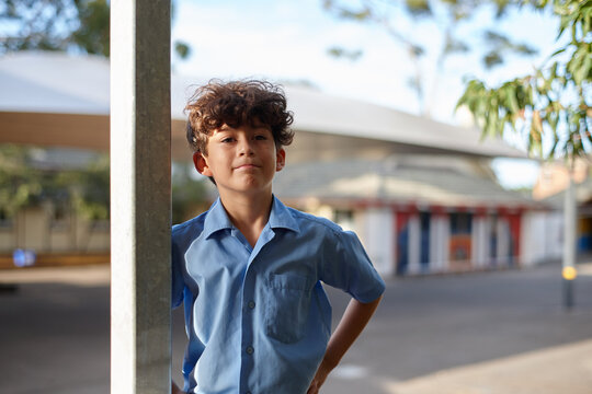 Young confident school boy at school grounds