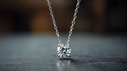 A minimalist diamond pendant with a solitaire gemstone on a sleek platinum chain