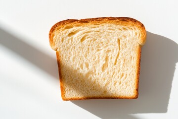 Golden brown loaf of freshly baked bread bright kitchen food photography soft daylight top view texture highlight