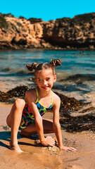 Happy toddler playing in the sand on a sunny beach. A joyful moment of childhood fun by the sea, building sandcastles and enjoying a beautiful summer day. Perfect vacation vibes