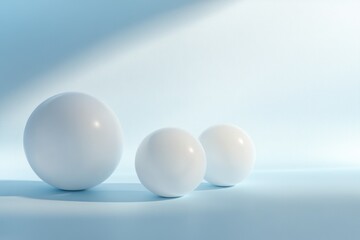 Three white spheres on a soft blue background