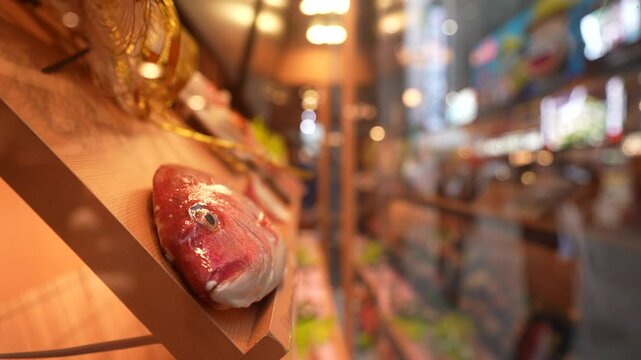 View of menu items in restaurant window in busy Dotonbori, vibrant entertainment district near the river, Osaka, Honshu, Japan