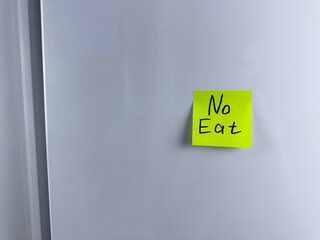 No eat. Reminder on refrigerator prohibiting eating