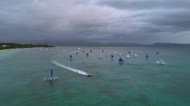 Traditional Sailboats and Speedboat on Tropical Waters Under Cloudy Sky