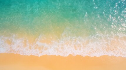 Aerial view of a tranquil beach with turquoise waters and soft sandy shore.